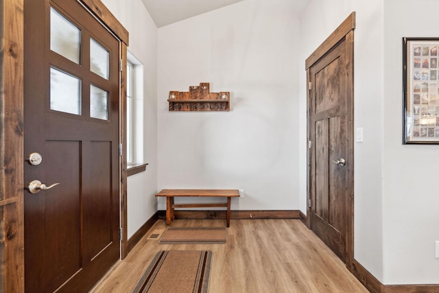 foyer entrance featuring light wood-type flooring and baseboards