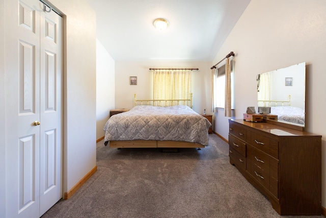 bedroom with baseboards and dark colored carpet