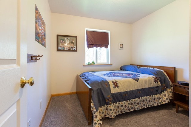 bedroom featuring carpet and baseboards