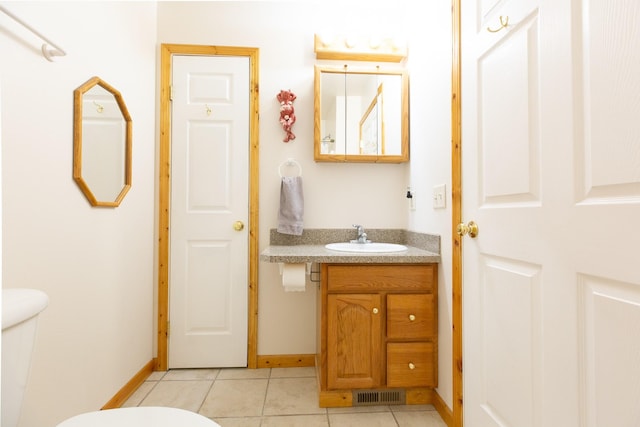 bathroom with visible vents, baseboards, toilet, tile patterned flooring, and vanity