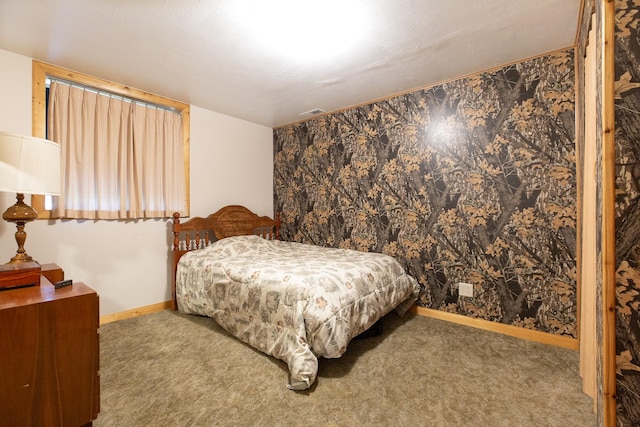 carpeted bedroom with visible vents and baseboards