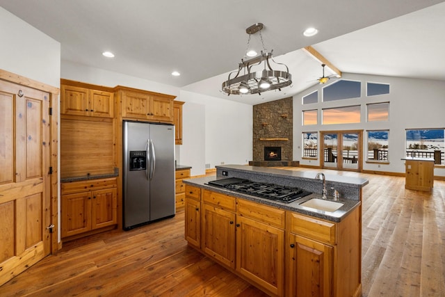 920 Antelope Ridge Rd, Belgrade, MT 59714 - kitchen with light wood-style flooring, a sink, open floor plan, stainless steel fridge, and ceiling fan
