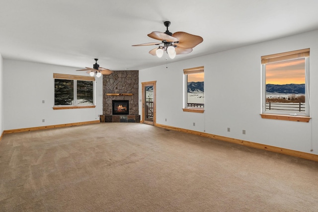 920 Antelope Ridge Rd, Belgrade, MT 59714 - unfurnished living room with a fireplace, carpet, baseboards, and a ceiling fan