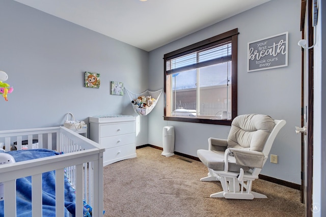 bedroom featuring a nursery area, visible vents, baseboards, and light colored carpet