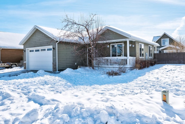 ranch-style home with a porch, an attached garage, and fence