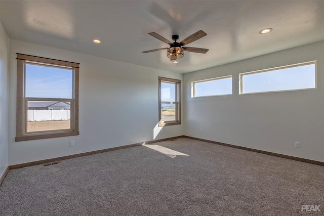 carpeted spare room with ceiling fan, baseboards, and recessed lighting