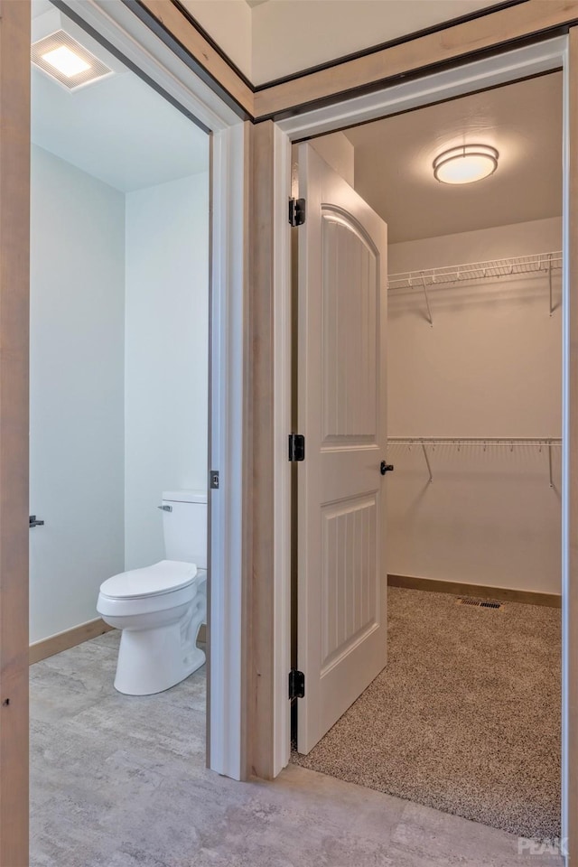 bathroom featuring visible vents, toilet, and baseboards