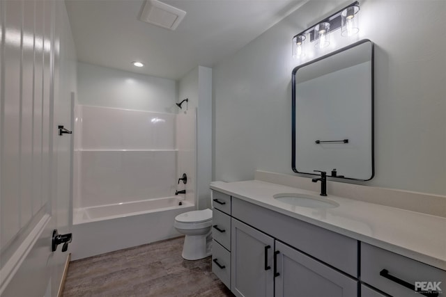 full bath featuring toilet, wood finished floors, visible vents, vanity, and  shower combination