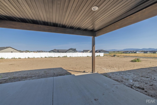 exterior space with a patio area, fence, and a mountain view