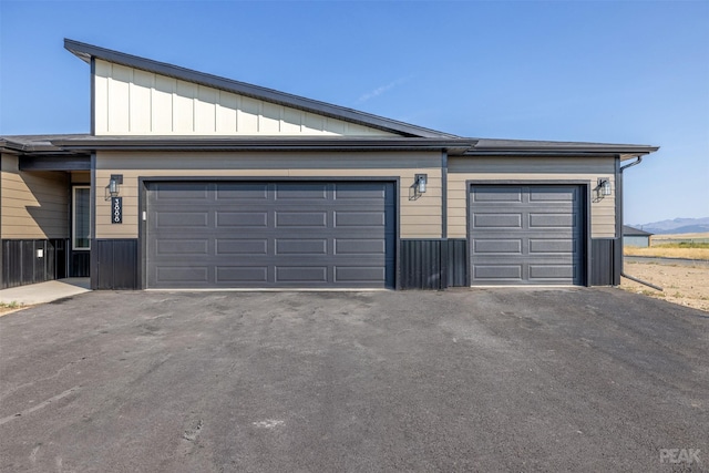 garage featuring aphalt driveway