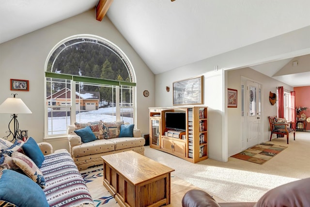 living room with lofted ceiling with beams and light colored carpet