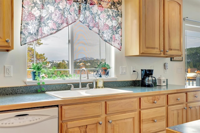 kitchen featuring a sink, light countertops, dishwasher, and light brown cabinetry