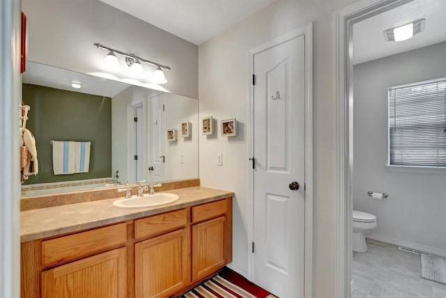 bathroom featuring a closet, visible vents, vanity, and toilet