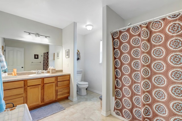 full bath featuring toilet, baseboards, and vanity