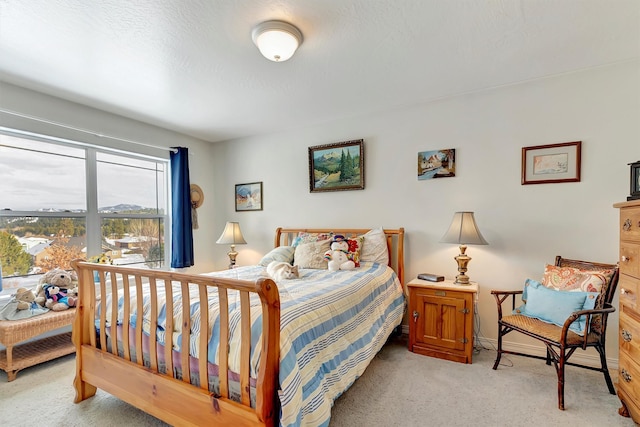 bedroom with light carpet and baseboards