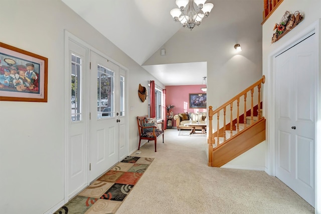 foyer with a notable chandelier, light colored carpet, high vaulted ceiling, baseboards, and stairs