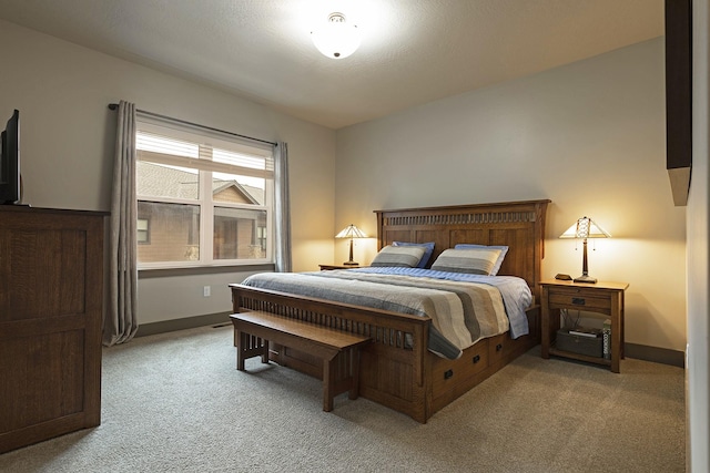 bedroom with light carpet and baseboards