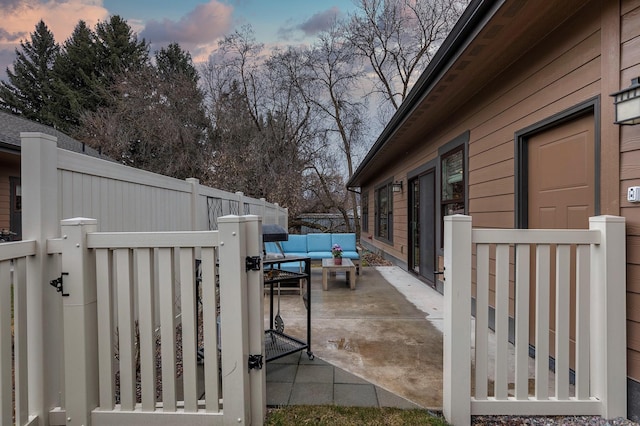 view of patio / terrace with a fenced backyard, a gate, and an outdoor hangout area