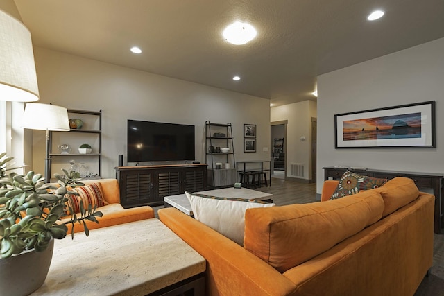 living area with dark wood-type flooring, recessed lighting, and visible vents