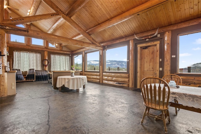 sunroom / solarium with vaulted ceiling with beams, wood ceiling, and a mountain view