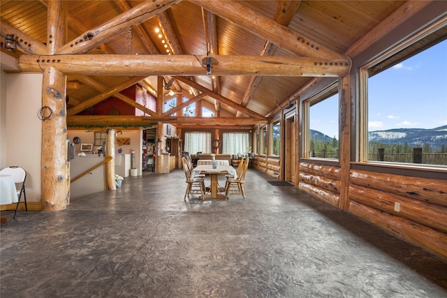 unfurnished dining area featuring beam ceiling, rustic walls, a mountain view, high vaulted ceiling, and wooden ceiling