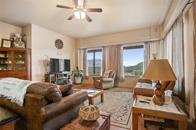 living area featuring a ceiling fan and lofted ceiling