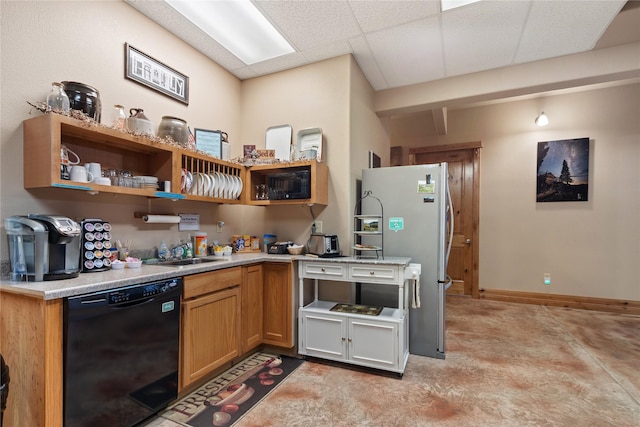 kitchen with a drop ceiling, light countertops, black appliances, open shelves, and a sink