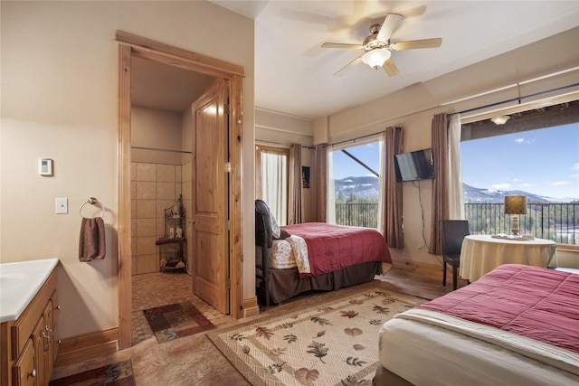 bedroom with access to outside, a ceiling fan, and baseboards