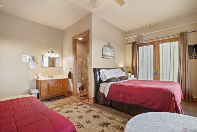 bedroom with ceiling fan, french doors, light carpet, and connected bathroom