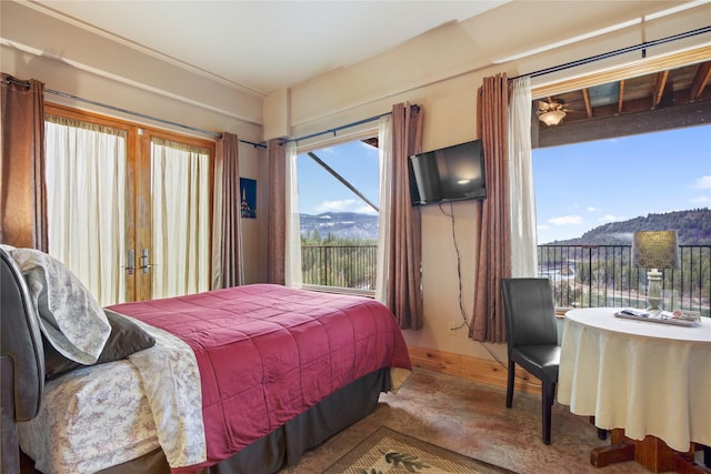 bedroom featuring access to outside and baseboards