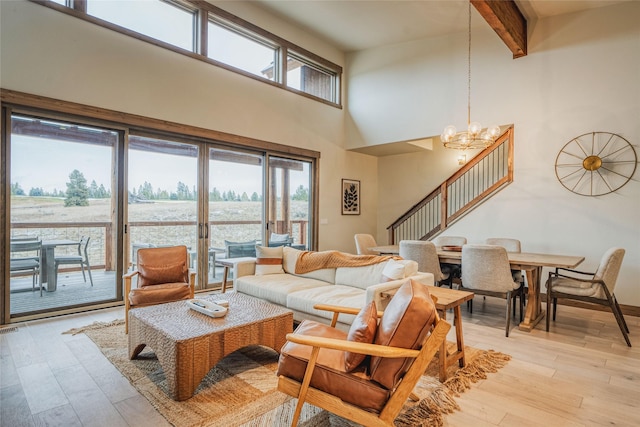 30 Ninebark Way, Eureka, MT 59917 - living area with beam ceiling, plenty of natural light, light wood-style flooring, and a towering ceiling