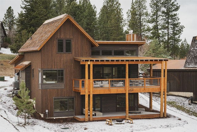30 Ninebark Way, Eureka, MT 59917 - snow covered rear of property with a chimney and a deck