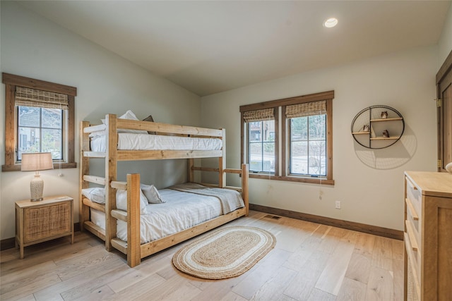 30 Ninebark Way, Eureka, MT 59917 - bedroom with baseboards, multiple windows, and light wood-type flooring