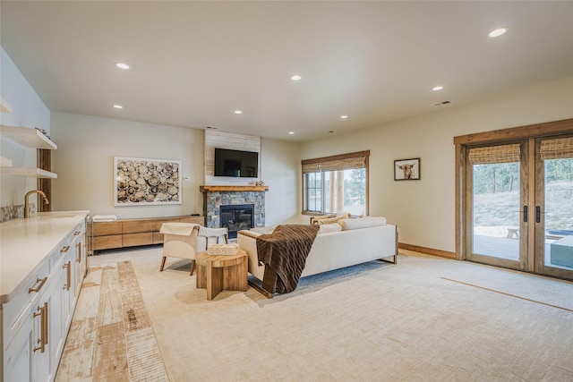 30 Ninebark Way, Eureka, MT 59917 - living area with french doors, light colored carpet, visible vents, recessed lighting, and a fireplace
