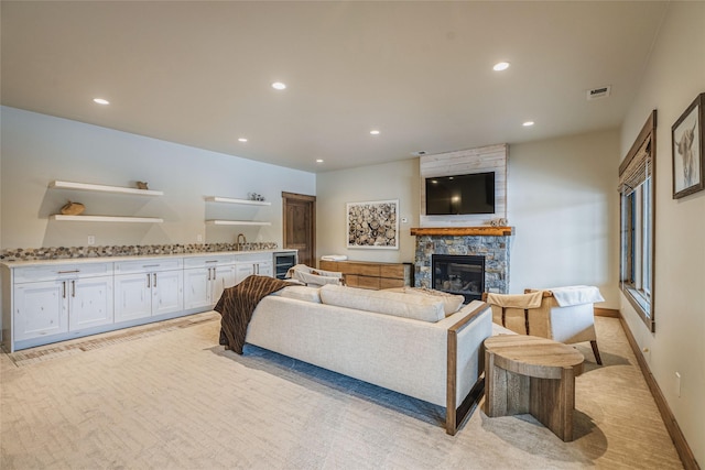 30 Ninebark Way, Eureka, MT 59917 - living room featuring wine cooler, a stone fireplace, visible vents, and recessed lighting