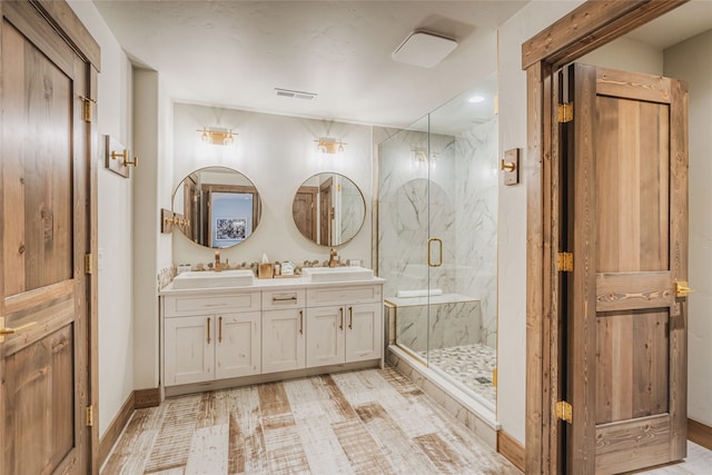30 Ninebark Way, Eureka, MT 59917 - bathroom featuring a sink, double vanity, a marble finish shower, and visible vents