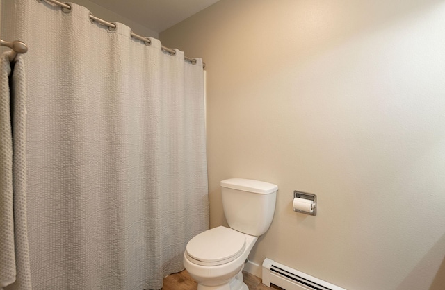 bathroom featuring a baseboard radiator, wood finished floors, and toilet