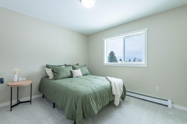 bedroom featuring a baseboard heating unit, carpet floors, and baseboards