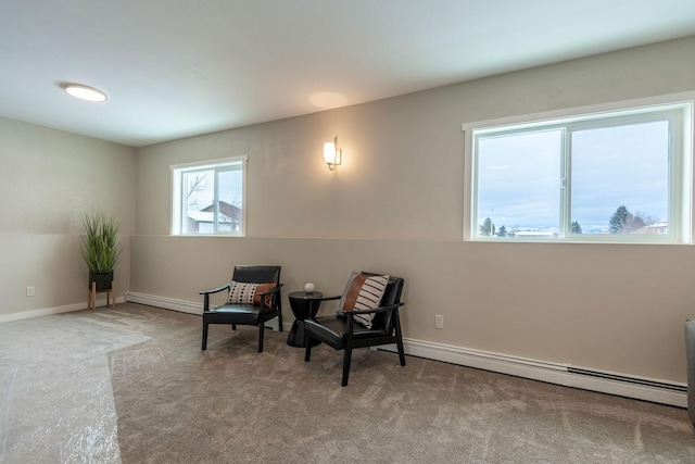 sitting room featuring a baseboard radiator, baseboards, and carpet