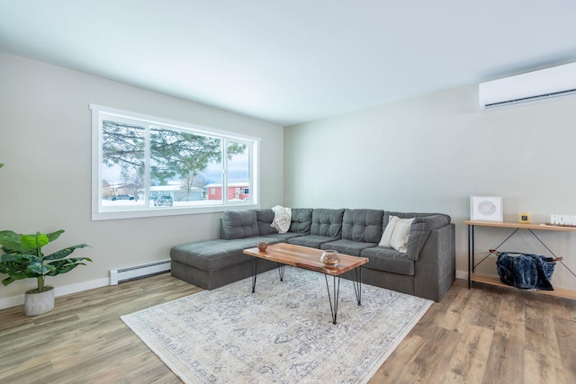 living room with baseboard heating, a wall mounted air conditioner, wood finished floors, and baseboards