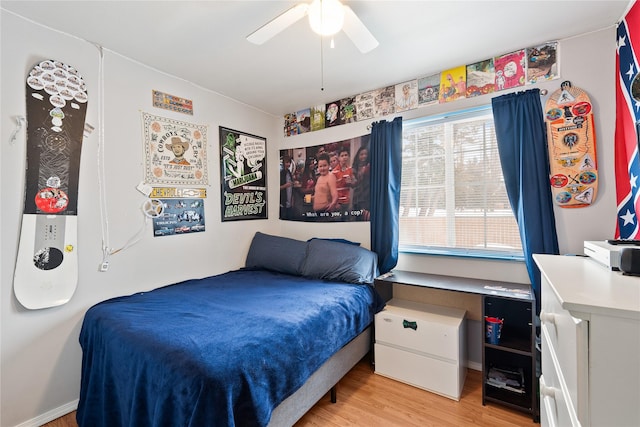 bedroom with light wood-style floors and a ceiling fan