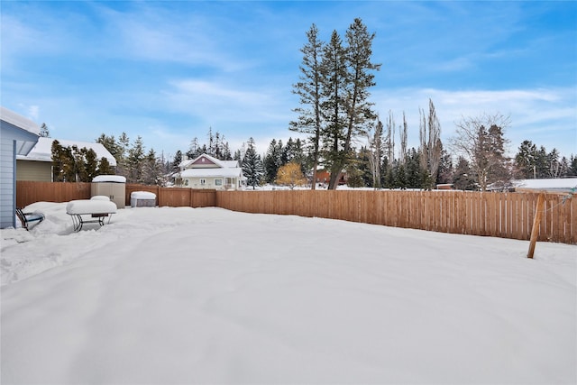 yard covered in snow featuring a fenced backyard