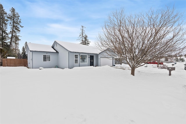 ranch-style house with a garage and fence