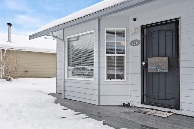 view of snow covered property entrance