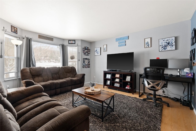 living area featuring wood finished floors and baseboards