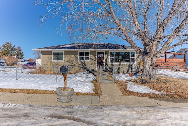 view of front of home featuring a fenced front yard and driveway