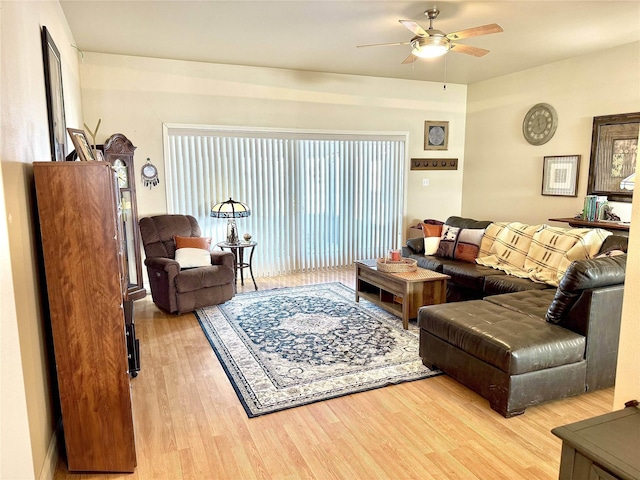 living area with a ceiling fan and wood finished floors