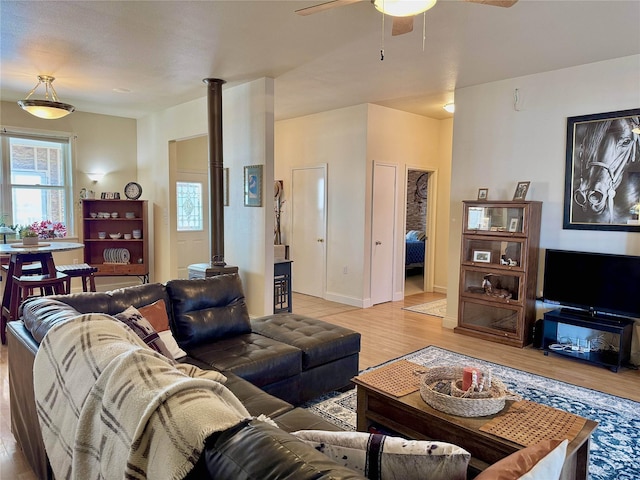 living room featuring light wood-type flooring and a ceiling fan