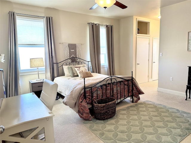 bedroom with a ceiling fan and baseboards