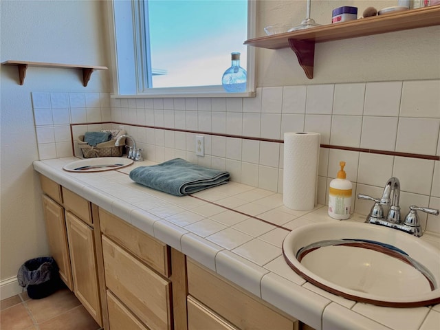 bathroom featuring decorative backsplash, a sink, and tile patterned floors